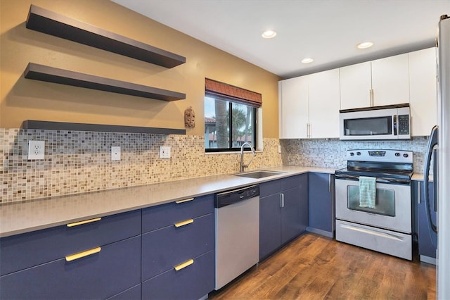 kitchen featuring dark wood-type flooring, stainless steel appliances, sink, decorative backsplash, and white cabinetry