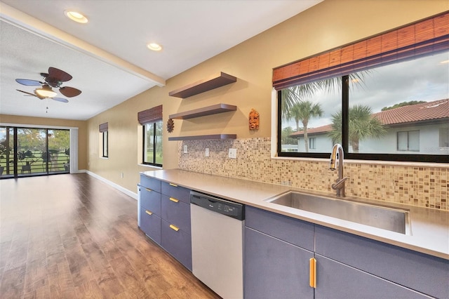 kitchen featuring backsplash, dishwasher, light hardwood / wood-style floors, sink, and ceiling fan