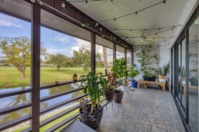 sunroom / solarium with a water view