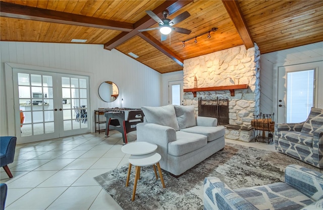 living room featuring a fireplace, french doors, ceiling fan, vaulted ceiling with beams, and wood ceiling