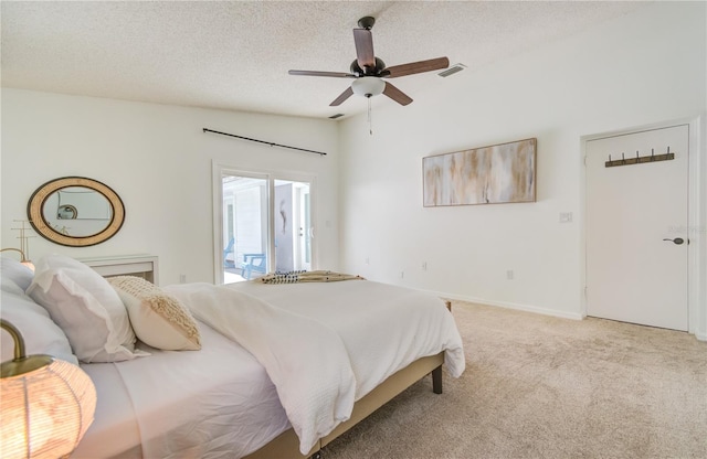 bedroom with a textured ceiling, access to outside, ceiling fan, vaulted ceiling, and light colored carpet