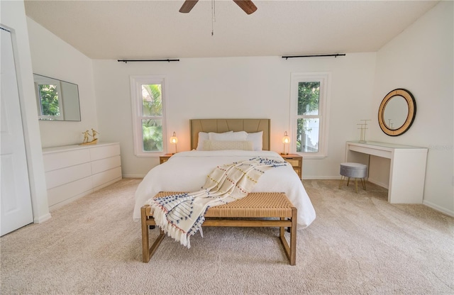 bedroom with light carpet and ceiling fan