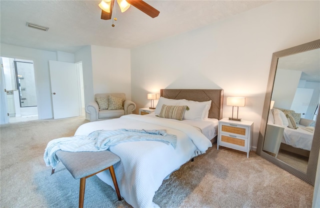 bedroom featuring light colored carpet, ceiling fan, and a textured ceiling