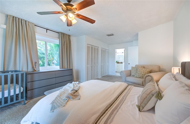 bedroom featuring ceiling fan, light carpet, and a textured ceiling