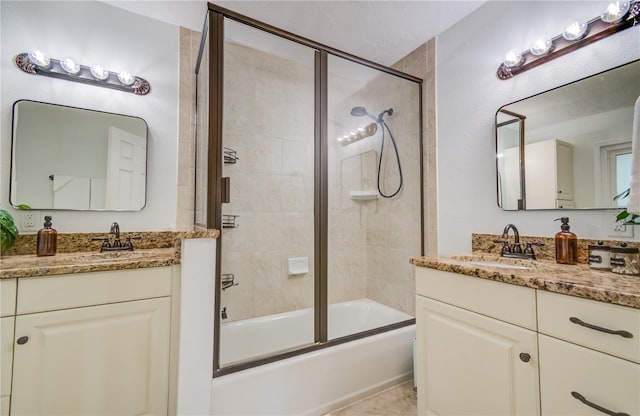 bathroom featuring vanity and bath / shower combo with glass door