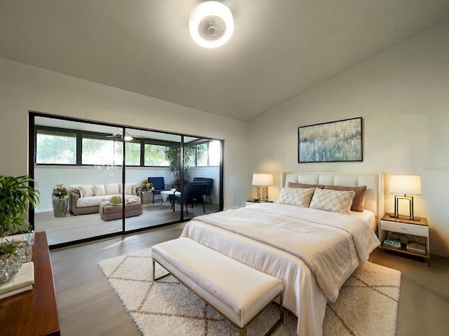 bedroom with lofted ceiling and hardwood / wood-style floors