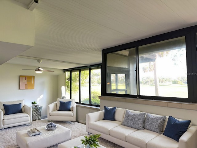 carpeted living room with ceiling fan