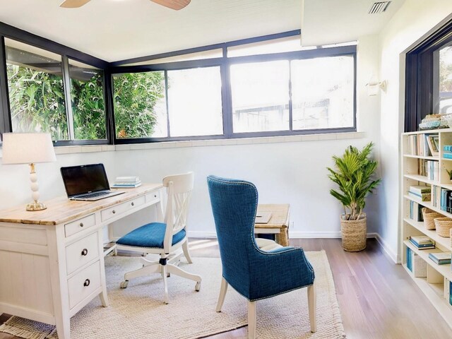 office space featuring light hardwood / wood-style flooring, lofted ceiling, and ceiling fan