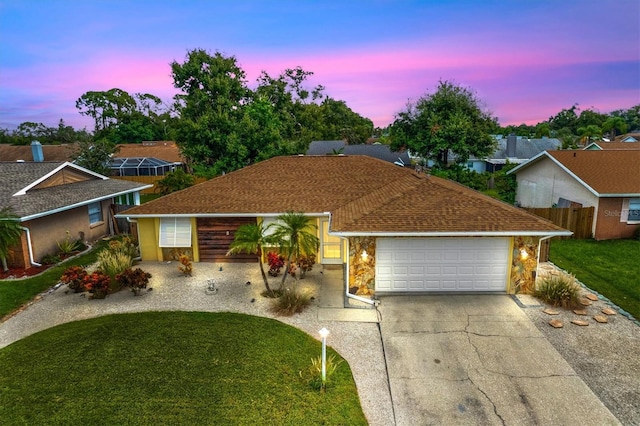 single story home with a lawn and a garage