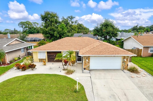 ranch-style home with a front lawn and a garage