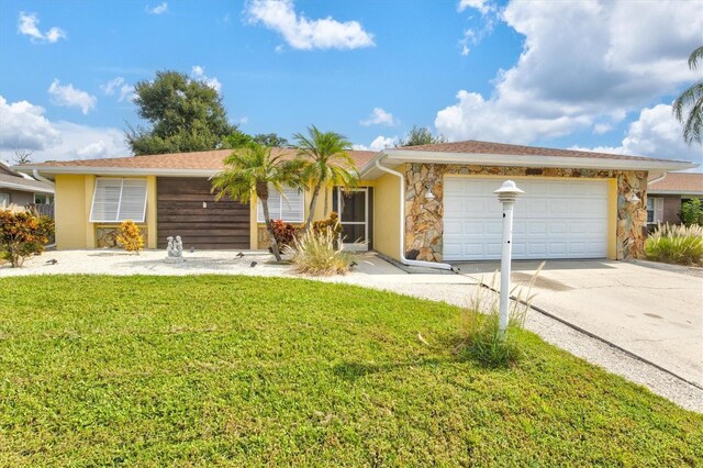 single story home featuring a garage and a front lawn