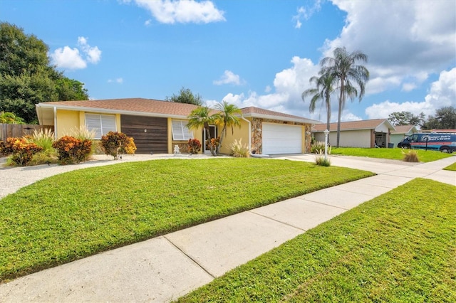 ranch-style house featuring a front lawn and a garage