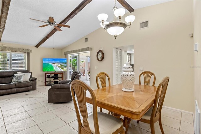 tiled dining room featuring a textured ceiling, ceiling fan with notable chandelier, and lofted ceiling with beams