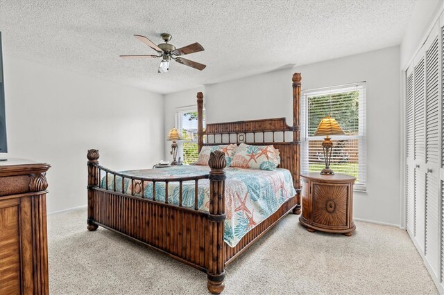 bedroom featuring ceiling fan, a closet, and multiple windows