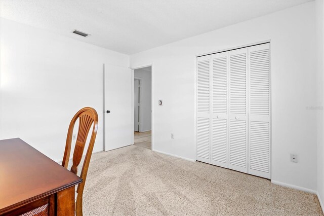 unfurnished office featuring light carpet