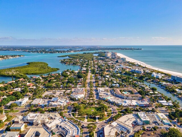 bird's eye view with a water view and a beach view