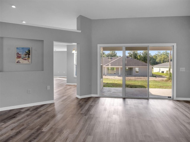 empty room with hardwood / wood-style floors