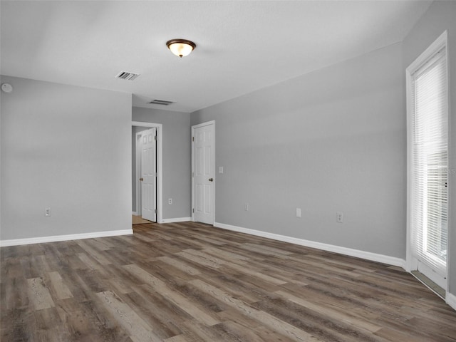 unfurnished room featuring dark hardwood / wood-style floors