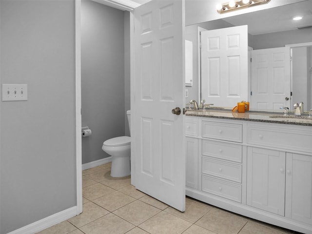 bathroom with vanity, toilet, and tile patterned flooring