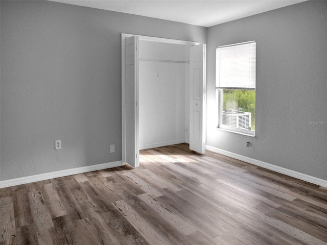 unfurnished bedroom with hardwood / wood-style floors and a closet