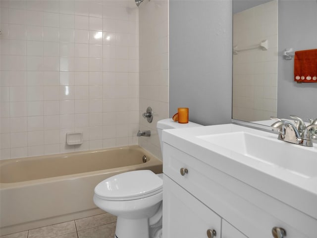 full bathroom with tile patterned flooring, vanity, tiled shower / bath combo, and toilet