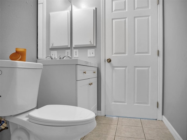 bathroom featuring tile patterned floors, toilet, and vanity