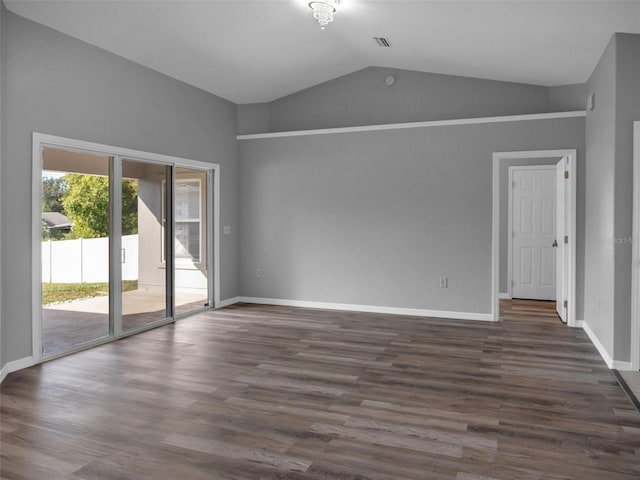 empty room featuring lofted ceiling and dark hardwood / wood-style floors