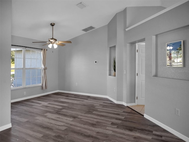 empty room featuring lofted ceiling, dark wood-type flooring, and ceiling fan