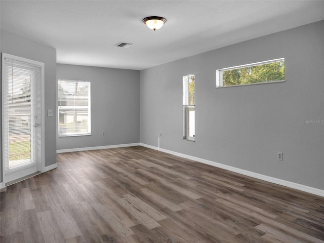 spare room with dark wood-type flooring