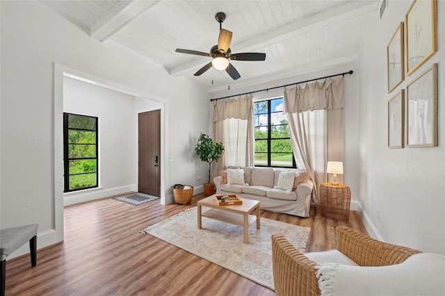 living room with beam ceiling, ceiling fan, hardwood / wood-style floors, and wood ceiling