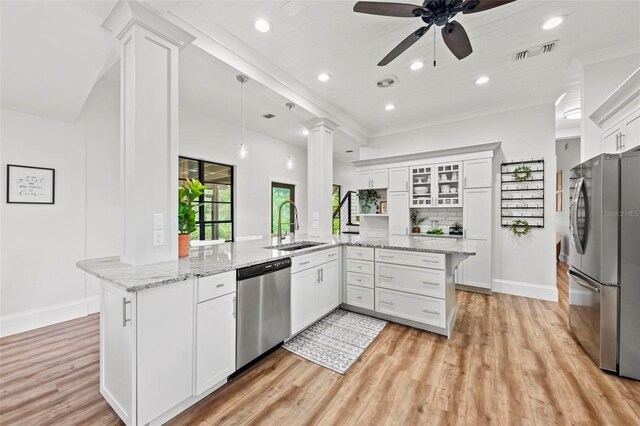 kitchen with white cabinetry, sink, kitchen peninsula, and stainless steel appliances