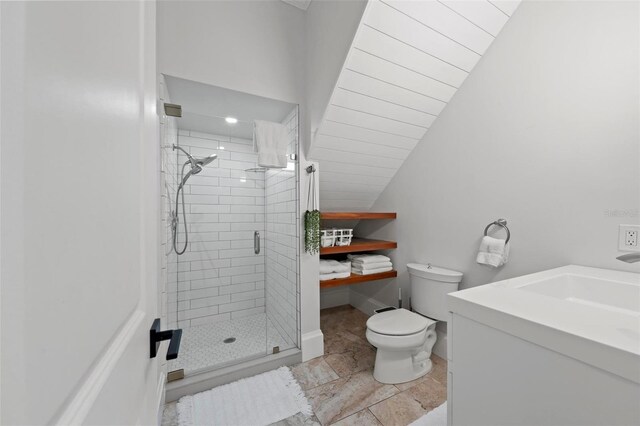 bathroom with tile patterned floors, lofted ceiling, toilet, vanity, and a shower with shower door