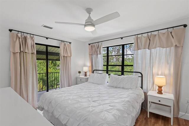 bedroom featuring hardwood / wood-style floors, access to outside, and ceiling fan