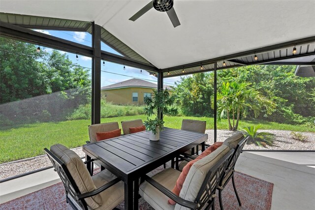 sunroom featuring ceiling fan and vaulted ceiling