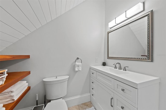 bathroom with vanity, toilet, baseboards, wood ceiling, and vaulted ceiling