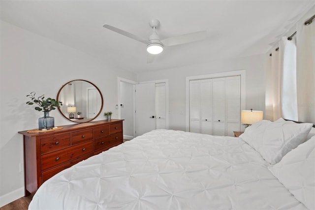 bedroom featuring a ceiling fan, baseboards, and wood finished floors