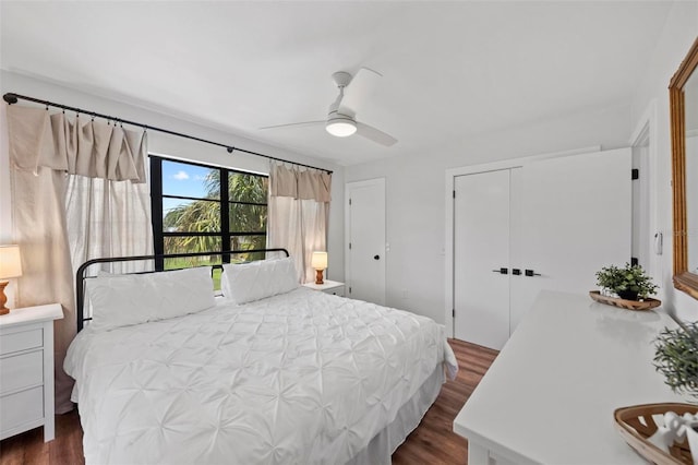 bedroom featuring a ceiling fan and dark wood-style flooring