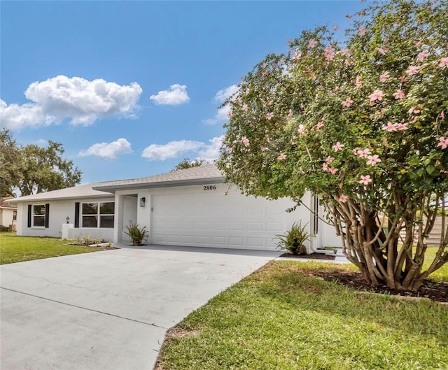 view of front of home featuring a front yard and a garage