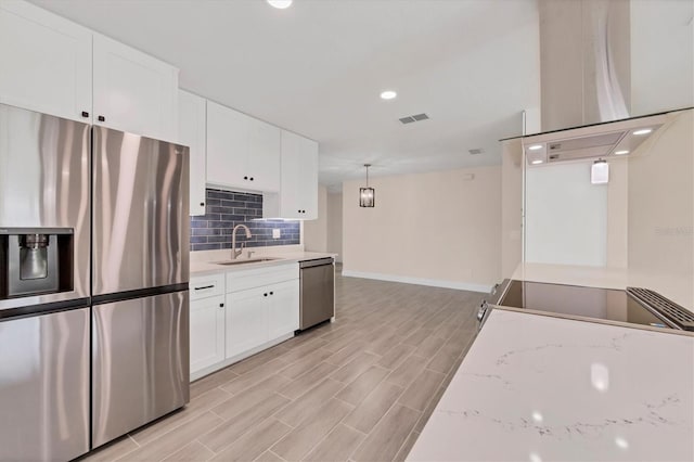 kitchen with white cabinetry, light hardwood / wood-style flooring, appliances with stainless steel finishes, and sink