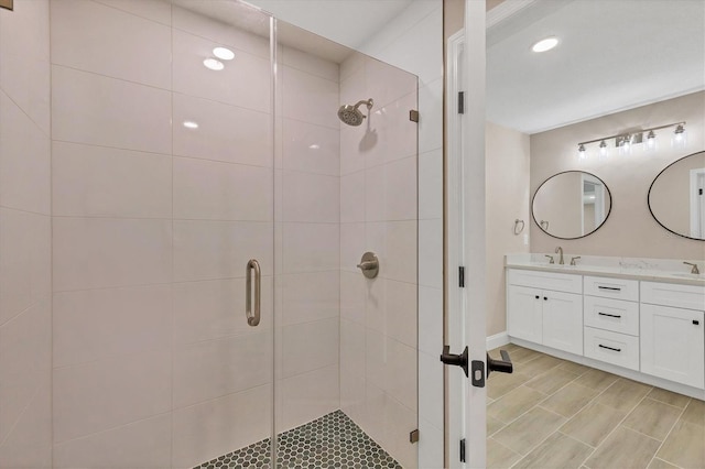 bathroom featuring vanity and an enclosed shower