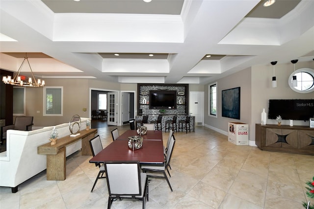 dining room with ornamental molding, a healthy amount of sunlight, coffered ceiling, and a notable chandelier