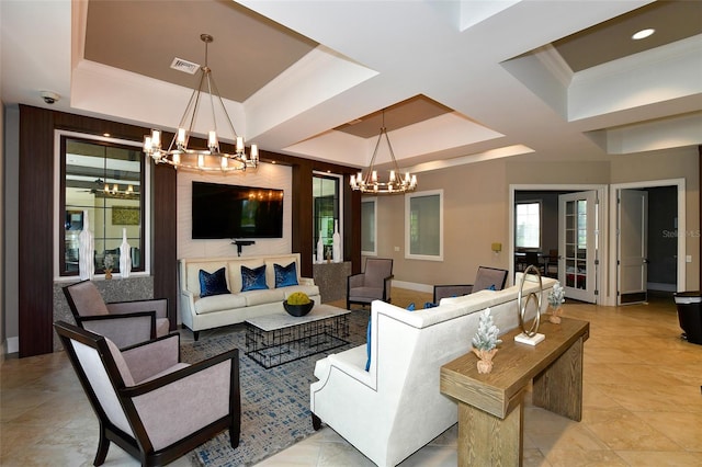 living room with crown molding, coffered ceiling, a chandelier, and a tray ceiling