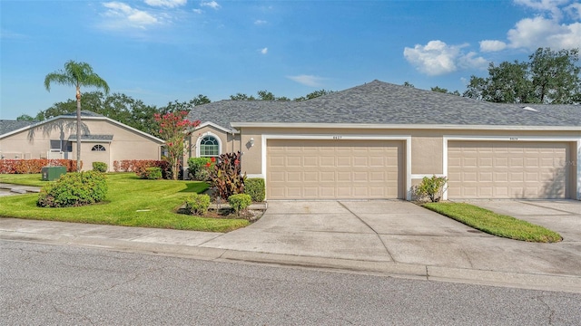 single story home featuring a front yard and a garage