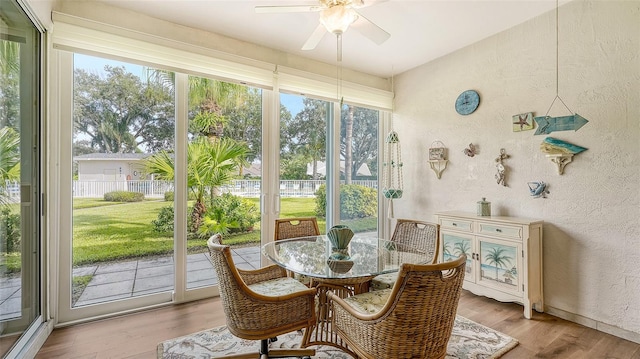 sunroom featuring ceiling fan