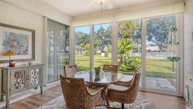 sunroom featuring ceiling fan