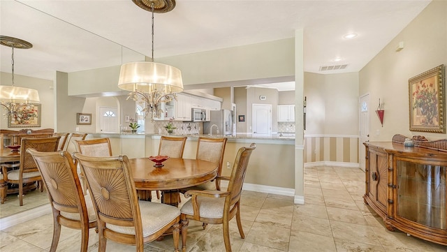 dining space with a notable chandelier