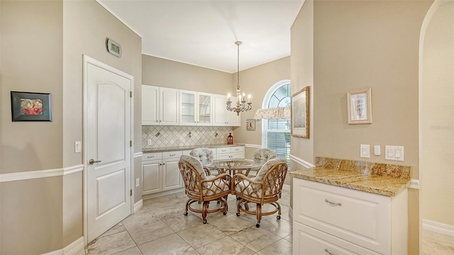 dining area featuring a notable chandelier and light tile patterned floors