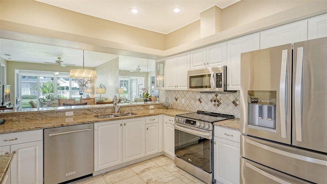 kitchen with white cabinets, ceiling fan, appliances with stainless steel finishes, and sink