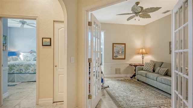 interior space with ceiling fan, light tile patterned flooring, and french doors