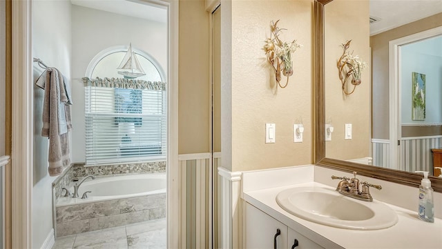 bathroom with vanity and a relaxing tiled tub